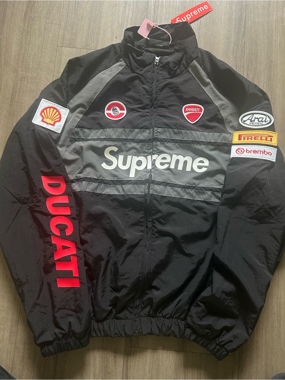 Supreme Black Windbreaker with Red Ducati Sleeve Logo and Gray Accent Panels